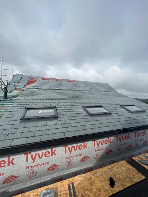 A roof stripped back to breathable membrane and battens partway through a repair